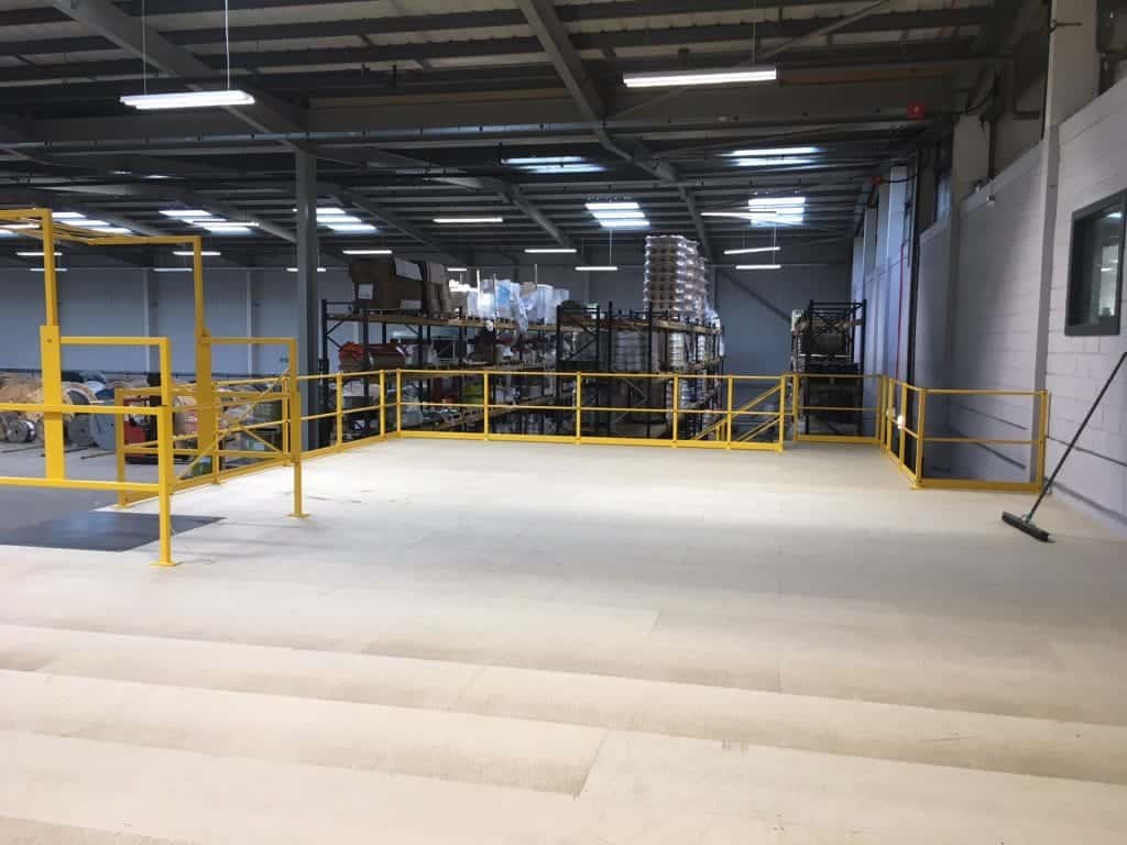 mezzanine floor in warehouse with yellow edge protection and pallet gate