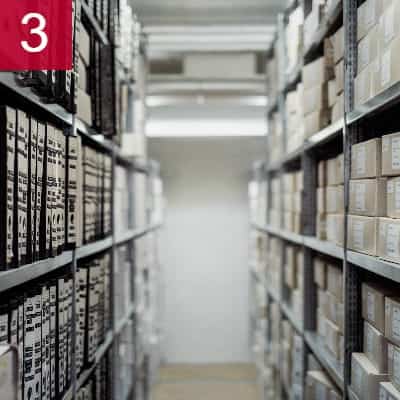 aisle of metal shelving filled with boxes