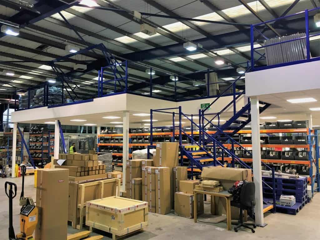 mezzanine floor with blue edge protection and staircase with shelving underneath