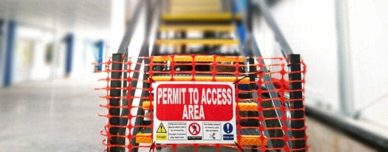 mezzanine floor staircase blocked by permit to access area sign and barrier