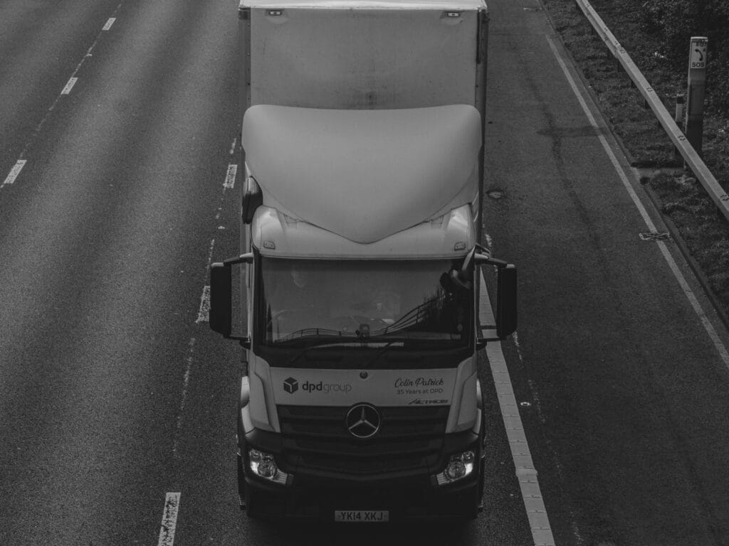 black and white front of DPD lorry on road