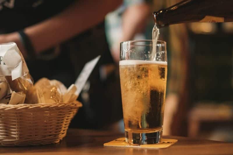beer being poured from bottle to glass