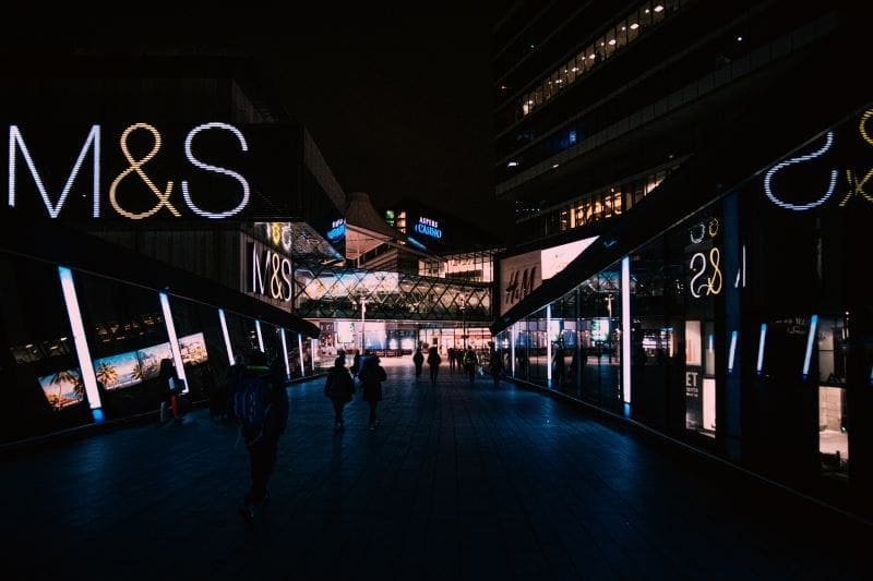 dark shopping mall showing M&S store