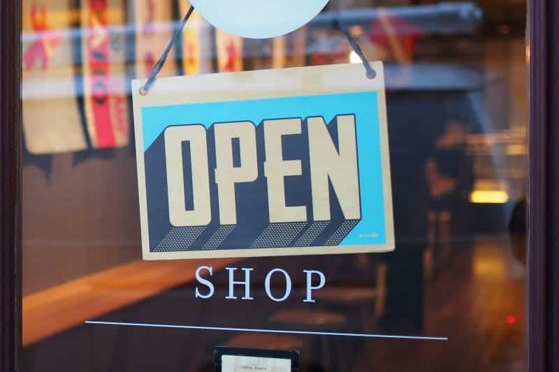 open sign hanging in shop window