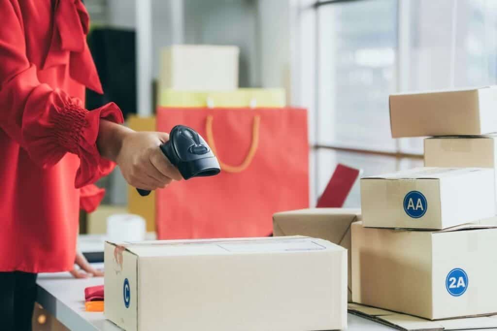 person using barcode scanner to scan parcel