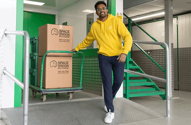 space station self storage customer with boxes on trolley